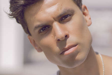 Close-up of a man's face with a piercing gazeの写真素材