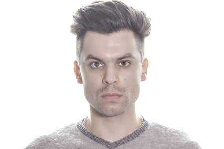 Portrait of a young attractive guy on isolated whiteの写真素材
