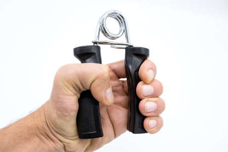 The exercise machine an expander, for hands on a white backgroundの写真素材