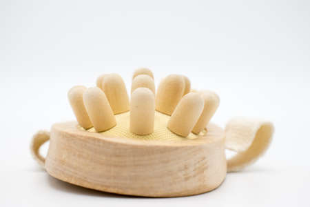 Massage comb from a tree with a belt on a handの写真素材