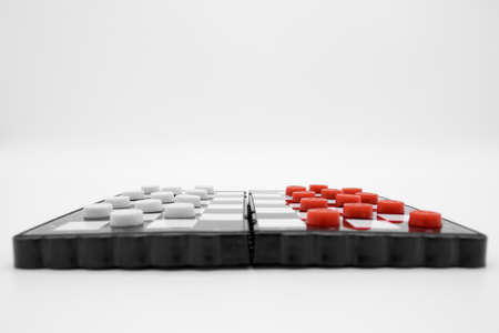 Pocket plastic chess game, checkers on magnets isolated on white backgroundの写真素材