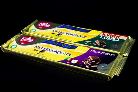 Oslo city, Norway 09/06/2019 Norwegian Chocolate Freia Melkesjokolade in different packages lies on a black isolated backgroundのeditorial素材
