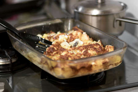Baked poultry meat with potatoes on a baking sheet, on a plate