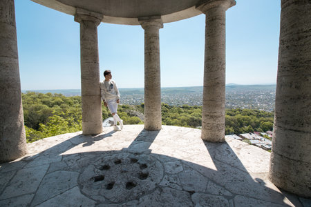 Pyatigorsk, Stavropol Territory, country Russia 01/05/2018 A Handsome guy posing in Pyatigorsk near the sights of the Eolian Harp on Mount Mashukのeditorial素材