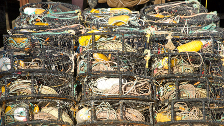 Many Crab cages stacked. Crab traps are used to bait, lure, and catch crabs for commercial or recreational use. Crabbing or crab fishing is the recreational hobby and commercial occupation of fishing.の写真素材