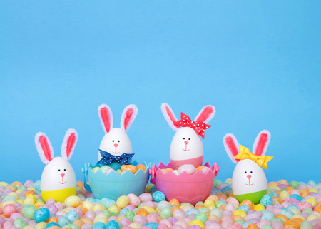 Craft Easter Bunnies made from plastic eggs Two in baskets full of candy with two standing in pastel...