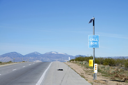 Kern County, CA - March 09, 2016: Call box on the side of the road along Interstate 58 in...