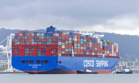 Oakland, CA - May 16, 2019: Multiple tugboats assisting Cargo Ship COSCO SHIPPING ROSE to maneuver out of the Port of Oakland, the fifth busiest port in the United States.のeditorial素材