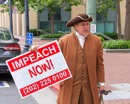 Oakland, CA - June 15, 2019: Unidentified protesters with signs in front of the Federal Courthouse, demanding an inquiry into the impeachment of Donald Trumpのeditorial素材