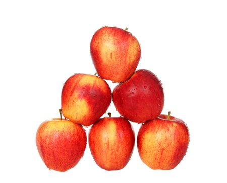 Whole gala apple stacked pyramid shape dripping with water drops isolated on white. Gala is a clonally propagated apple cultivar with a mild and sweet flavor.の写真素材