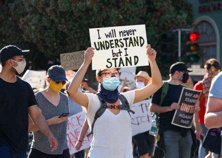 San Francisco, CA - June 3, 2020: Protestors at the George Floyd Black Lives Matter protest, some marching from Mission High School to Mission Police Dept and some to City Hall, holding signs.のeditorial素材
