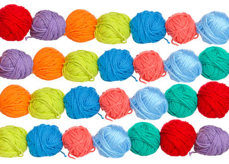 Balls of yarn in vibrant colors in symmetrical rows.