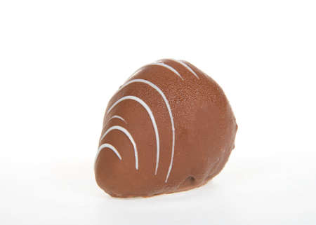 Close up on giant strawberry dipped completely in milk chocolate, drizzled with contrasting white chocolate. Isolated on white.の写真素材