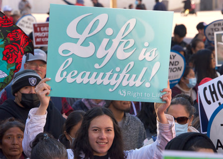 San Francisco, CA - Jan 21, 2023: Unidentified participants in the annual March for Life, holding pro-life signs and banners, walking down Market street towards the Embarcadero.のeditorial素材