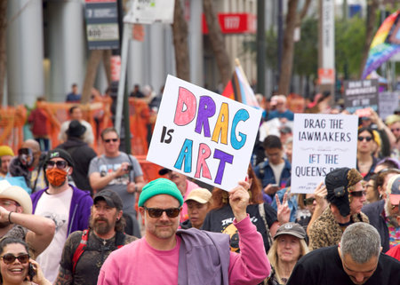 San Francisco, CA - April 8, 2023: Participants in the Drag Up Fight Back protest marching from Civic Center to Union Square. Holding signs.のeditorial素材