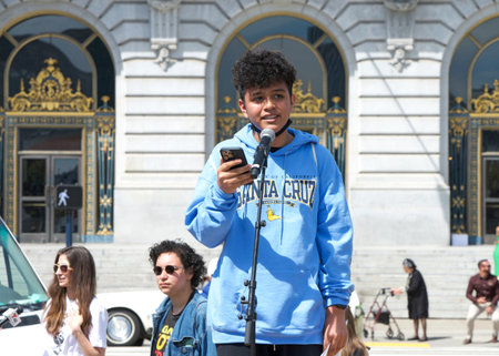 San Francisco, CA - April 21, 2023: Unidentified participants of Youth vs Apocalypse Climate Protesting in front of City Hall, speaking to the group.のeditorial素材