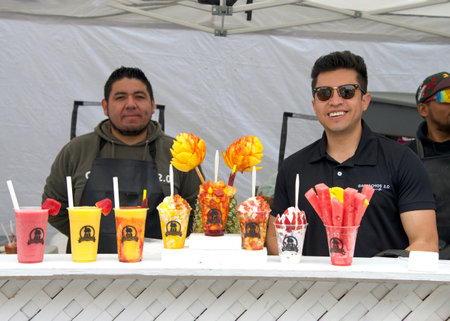 San Francisco, CA - May 27, 2023: Unidentified participants at Carnaval Festival in the Mission District, vendor on Harrison Street selling fruit smoothy beverages in various flavors.のeditorial素材