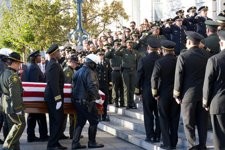 San Francisco, CA - Oct 4, 2023: Police and Fire Fighters stand at attention as the casket with the...