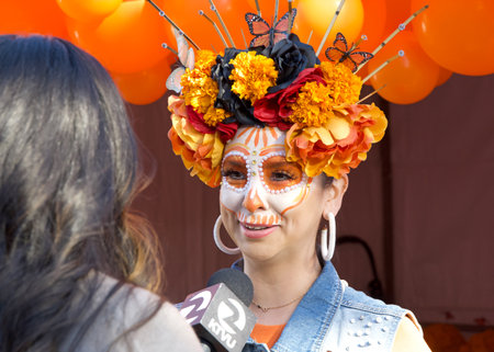 Oakland, CA - Oct 29, 2023: Channel 2 news interviewing participant at the annual Dia de los Muertos, or Day of the Dead festival. One of the most popular holidays celebrated in Mexico.のeditorial素材