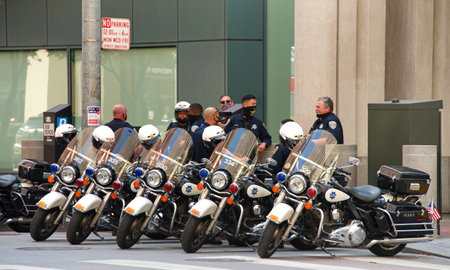 San Francisco, CA - Sept 5, 2020: SF Police standby as a Protesters Protest at the Embarcadero to Demand Trump Pence Out Now! Bay Area event organized by Refuse Fascism Bay Area.のeditorial素材