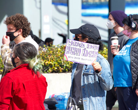Oakland, CA - Feb 20, 2021: Unidentified participants protesting Amazon's treatment of employees and their attempts to bust up formation of a union for workers. Outside Whole Foods carrying signs.のeditorial素材