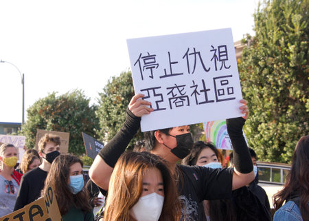 Alameda, CA - March 24, 2021: Unidentified participants at a youth lead anti-Asian Violence March,...