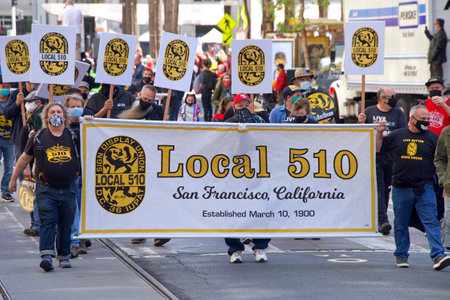 San Francisco, CA - May 1, 2021: Unidentified participants marching up Market Street celebrating May Day, also known as International Workersâ Day.のeditorial素材