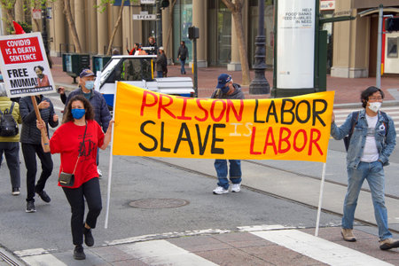 San Francisco, CA - May 1, 2021: Unidentified participants marching up Market Street celebrating May Day, also known as International Workersâ Day.のeditorial素材