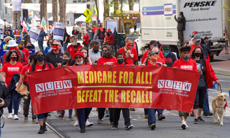 San Francisco, CA - May 1, 2021: Unidentified participants marching up Market Street celebrating May Day, also known as International Workersâ Day.のeditorial素材