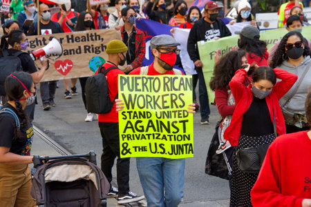 San Francisco, CA - May 1, 2021: Unidentified participants marching up Market Street celebrating May Day, also known as International Workersâ Day.のeditorial素材