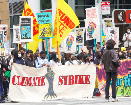San Francisco, CA - March 25, 2022: Youth lead climate strike marching up Market street from...