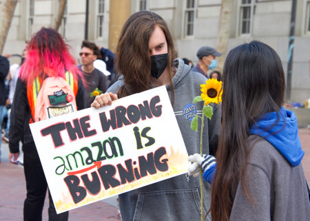 San Francisco, CA - April 22, 2022: Participants of youth lead climate strike in front of City hall, holding signs and vocalizing demands to address climate change.のeditorial素材