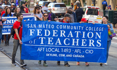 San Francisco, CA - May 1, 2022: Unidentified participants marching up Market Street celebrating May Day, also known as International Workersâ Day.のeditorial素材