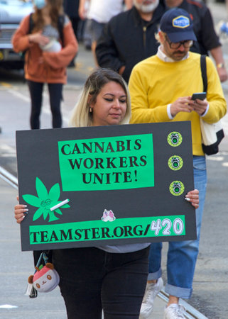 San Francisco, CA - May 1, 2022: Unidentified participants marching up Market Street celebrating May Day, also known as International Workersâ Day.のeditorial素材