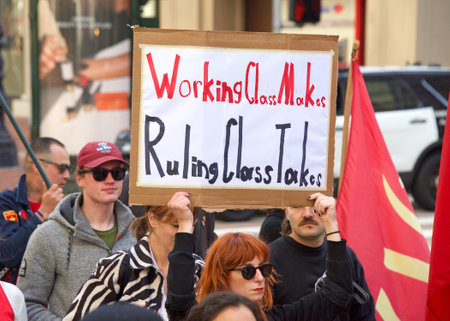 San Francisco, CA - May 1, 2022: Unidentified participants marching up Market Street celebrating May Day, also known as International Workersâ Day.のeditorial素材
