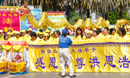 San Francisco, CA - May 7, 2022: Unidentified participants of the Falun Dafa meditation group on the Embarcadero, holding signs and banner preparing to march on city streets.のeditorial素材