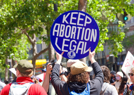 San Francisco, CA - May 7, 2022: Unidentified Participants holding signs marching in San Francisco at Womenâs Rights Protest after SCOTUS leak plan to overturn Roe v Wade.のeditorial素材