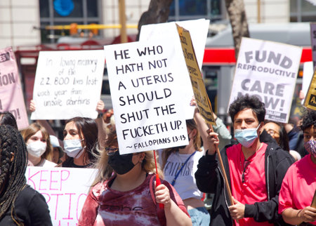 San Francisco, CA - May 7, 2022: Unidentified Participants holding signs marching in San Francisco at Womenâs Rights Protest after SCOTUS leak plan to overturn Roe v Wade.のeditorial素材