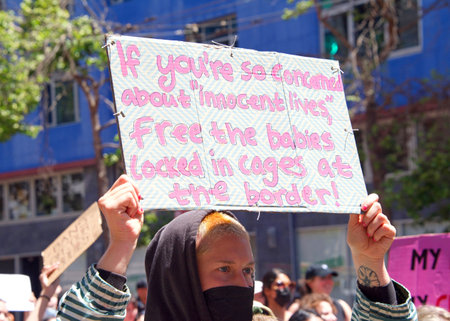 San Francisco, CA - May 7, 2022: Unidentified Participants holding signs marching in San Francisco...