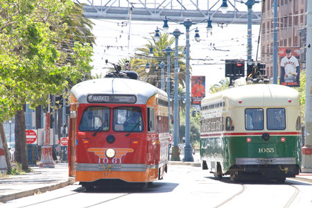 San Francisco, CA - Jan 23, 2022: Muni Bus on Market and Big Bus Tours driving down Market street near the Embarcadero. Clean air vehicles.のeditorial素材