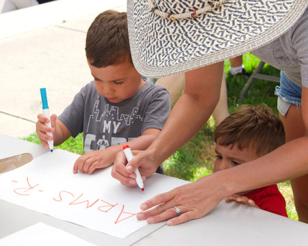 Oakland, CA - June 11, 2022:  Participants at the March for our Lives Protest Rally at Frank H Ogawa Plaza in Oakland, holding signs demanding action against gun violence.のeditorial素材