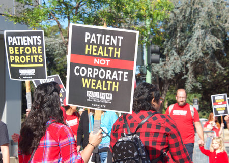 Oakland, CA - August 22, 2022:  Mental Health Care workers protesting outside Kaiser Medical Center on Broadway. Demanding Patient health be prioritized over corporate wealth. Patients before profits.のeditorial素材