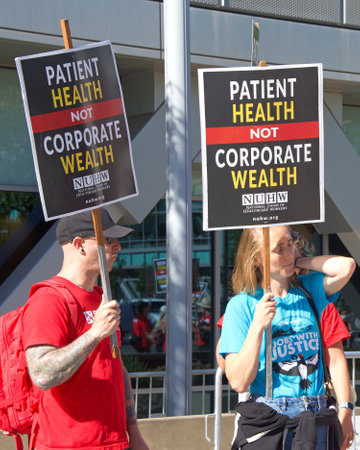 Oakland, CA - August 22, 2022:  Mental Health Care workers protesting outside Kaiser Medical Center on Broadway. Demanding Patient health be prioritized over corporate wealth. Patients before profits.のeditorial素材