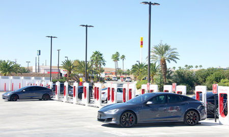 Kettleman City, CA - Oct 7, 2022: Tesla Supercharger station with 40 charging stations all on solar power. Supercharger stations allow Tesla cars to be fast-charged at the network within a hour.のeditorial素材