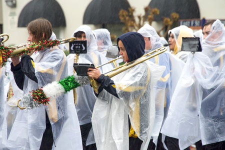 Benicia, CA - Dec 10, 2022: Unidentified participants in the annual Christmas Parade, featuring local marching bands, dancers, and the much anticipated Santa Claus. Walking in the rain.のeditorial素材