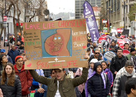 San Francisco, CA - Jan 20, 2024: Thousands of participants in the annual March for Life, holding pro-life signs and banners, walking down Market street towards the Embarcadero.のeditorial素材