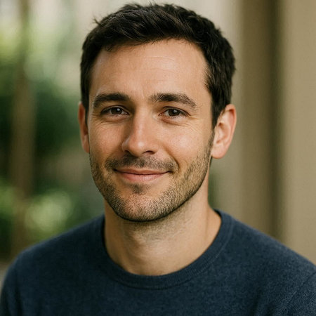 Portrait of a handsome man with a blue shirt smiling at the camera