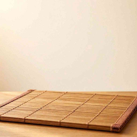 Bamboo place mat on wooden table with copy space for design.