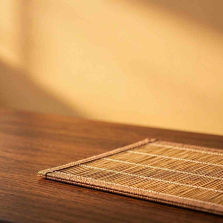 Bamboo place mat on wooden table. Selective focus. Copy space.