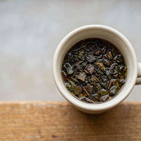 A cup of green tea on a wooden table. Close-up.